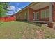 Spacious backyard with lush grass and mature trees with a red privacy fence at 735 Scenic Creek Dr, Lawrenceville, GA 30046