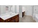 Bright bathroom featuring double vanities, shower, and tub combo at 735 Scenic Creek Dr, Lawrenceville, GA 30046