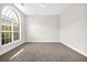 Neutral bedroom with large arched window and new carpet at 735 Scenic Creek Dr, Lawrenceville, GA 30046