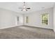 Bright bedroom with plush carpet, neutral walls, and large windows at 735 Scenic Creek Dr, Lawrenceville, GA 30046