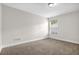 Neutral bedroom features a ceiling light and a window at 735 Scenic Creek Dr, Lawrenceville, GA 30046