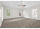 Spacious bedroom featuring plush carpeting, large windows, and a ceiling fan at 735 Scenic Creek Dr, Lawrenceville, GA 30046
