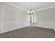 Traditional dining room featuring elegant chandelier and chair rail molding at 735 Scenic Creek Dr, Lawrenceville, GA 30046