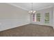 Dining area featuring chair-rail moulding, chandelier, and natural light at 735 Scenic Creek Dr, Lawrenceville, GA 30046