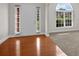 Bright foyer with hardwood flooring transitioning to carpet, flanked by sidelight windows at 735 Scenic Creek Dr, Lawrenceville, GA 30046