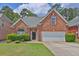 Charming red brick home with a manicured lawn and a two-car garage at 735 Scenic Creek Dr, Lawrenceville, GA 30046