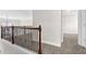 Upstairs hallway with dark wood railing and neutral carpet at 735 Scenic Creek Dr, Lawrenceville, GA 30046