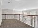 Hallway with dark metal railing and neutral carpet at 735 Scenic Creek Dr, Lawrenceville, GA 30046