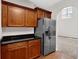 Kitchen featuring granite countertops, wood cabinets and stainless steel refrigerator at 735 Scenic Creek Dr, Lawrenceville, GA 30046