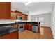 Modern kitchen with stainless steel appliances, granite counters, and hardwood floors at 735 Scenic Creek Dr, Lawrenceville, GA 30046