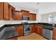 Kitchen with stainless steel appliances, wood cabinets, and granite countertops at 735 Scenic Creek Dr, Lawrenceville, GA 30046
