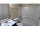 Well-lit bathroom with a clean vanity, sink, toilet, and shower-tub combo at 7518 Edenberry Way, Lithonia, GA 30058