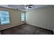 A Primary bedroom features a ceiling fan, neutral paint, and carpet at 7518 Edenberry Way, Lithonia, GA 30058