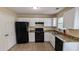 Efficient kitchen with white cabinets, granite countertops, and black appliances for a modern feel at 7518 Edenberry Way, Lithonia, GA 30058