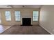 Open living room with a fireplace, neutral paint, and carpet, offering a cozy atmosphere at 7518 Edenberry Way, Lithonia, GA 30058