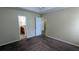 Spacious main bedroom with en-suite bathroom and neutral-toned walls and carpet at 7518 Edenberry Way, Lithonia, GA 30058