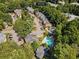 Aerial view of the community with mature trees, ample parking, and a refreshing community pool at 1106 Rock Creek Ln, Norcross, GA 30093