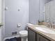 Bathroom with dark gray cabinets, granite countertop, and a large mirror at 1106 Rock Creek Ln, Norcross, GA 30093