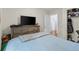 Bright bedroom with hardwood flooring, TV, closet, and soft blue comforter at 1106 Rock Creek Ln, Norcross, GA 30093