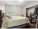 Bedroom with dark wood floors, a large window, and a desk at 1106 Rock Creek Ln, Norcross, GA 30093