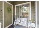 Inviting front porch with a charming welcome sign, a bench with pillows and decorative wreath at 1106 Rock Creek Ln, Norcross, GA 30093