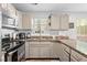 Modern kitchen featuring stainless steel appliances, ample cabinet space, and a stylish backsplash at 1106 Rock Creek Ln, Norcross, GA 30093