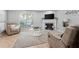 Spacious living room with a decorative fireplace, large window, and cozy seating arrangement at 1106 Rock Creek Ln, Norcross, GA 30093