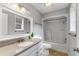 Well-lit bathroom with a single sink vanity, large mirror, and shower-tub combo at 1596 Foote Ne St, Atlanta, GA 30307
