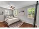 Bright bedroom with large windows, comfortable bed, stylish rug, and neutral decor at 1596 Foote Ne St, Atlanta, GA 30307