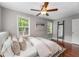 Bedroom with wood floors, natural light from the two windows, a ceiling fan, and neutral decor at 1596 Foote Ne St, Atlanta, GA 30307
