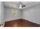 A neutral bedroom with hardwood floors, ceiling fan, and double door closet at 1596 Foote Ne St, Atlanta, GA 30307