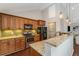 Well-lit kitchen with granite counters, stainless steel appliances, tiled backsplash, and dark cabinetry at 1596 Foote Ne St, Atlanta, GA 30307