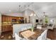 Sunlit kitchen and dining area with granite countertops, dark cabinets, wood floors, and stainless appliances at 1596 Foote Ne St, Atlanta, GA 30307