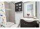 bathroom features a modern vanity and a shower-tub combination with playful decor at 2119 Dee Dee Muse Nw Ln, Atlanta, GA 30318