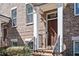Charming brick townhome entrance featuring a wooden door, white pillars, and a clear house number at 2119 Dee Dee Muse Nw Ln, Atlanta, GA 30318