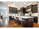 Stylish kitchen featuring a dark island, marble countertops, and stainless steel appliances at 2119 Dee Dee Muse Nw Ln, Atlanta, GA 30318