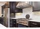 Well-equipped kitchen with stainless steel appliances, dark cabinetry, and marble backsplash detail at 2119 Dee Dee Muse Nw Ln, Atlanta, GA 30318