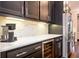 Close-up of a modern kitchen with stainless steel appliances, wine cooler, and marble countertops at 2119 Dee Dee Muse Nw Ln, Atlanta, GA 30318