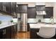 Modern kitchen showcasing dark wood cabinets, stainless steel refrigerator, and marble backsplash at 2119 Dee Dee Muse Nw Ln, Atlanta, GA 30318