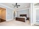 Spacious main bedroom with a dark wood bed frame and a large window at 2119 Dee Dee Muse Nw Ln, Atlanta, GA 30318
