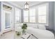 Cozy seating area with white sofa, large windows with plantation shutters, and stylish decor at 2119 Dee Dee Muse Nw Ln, Atlanta, GA 30318