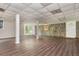 View of the basement featuring modern vinyl plank flooring, stone accent wall, and multiple doors to other rooms at 4855 Brownsville Rd, Powder Springs, GA 30127