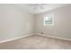 A cozy carpeted bedroom features a ceiling fan, a window for natural light, and neutral paint at 4855 Brownsville Rd, Powder Springs, GA 30127