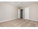 A bedroom features neutral walls, carpet, a ceiling fan and two white doors at 4855 Brownsville Rd, Powder Springs, GA 30127
