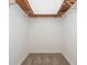 A walk-in closet with carpeted floors and custom wooden shelving for organized storage at 4855 Brownsville Rd, Powder Springs, GA 30127