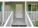 Inviting front entrance with white railings and a white door flanked by dark green shutters and matching trim at 4855 Brownsville Rd, Powder Springs, GA 30127
