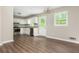 The kitchen boasts white cabinets, stainless steel appliances, and a door leading to the backyard at 4855 Brownsville Rd, Powder Springs, GA 30127