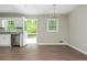 Open eat-in kitchen with stainless appliances, wood floors, and view to the deck at 4855 Brownsville Rd, Powder Springs, GA 30127