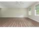Spacious and open living room with hardwood flooring and multiple windows that bring in lots of natural light at 4855 Brownsville Rd, Powder Springs, GA 30127
