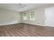 A spacious living room features hardwood flooring, a ceiling fan, and two windows with shade coverings at 4855 Brownsville Rd, Powder Springs, GA 30127